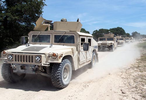 Photograph of American Army HUMVEE vehicles on road.